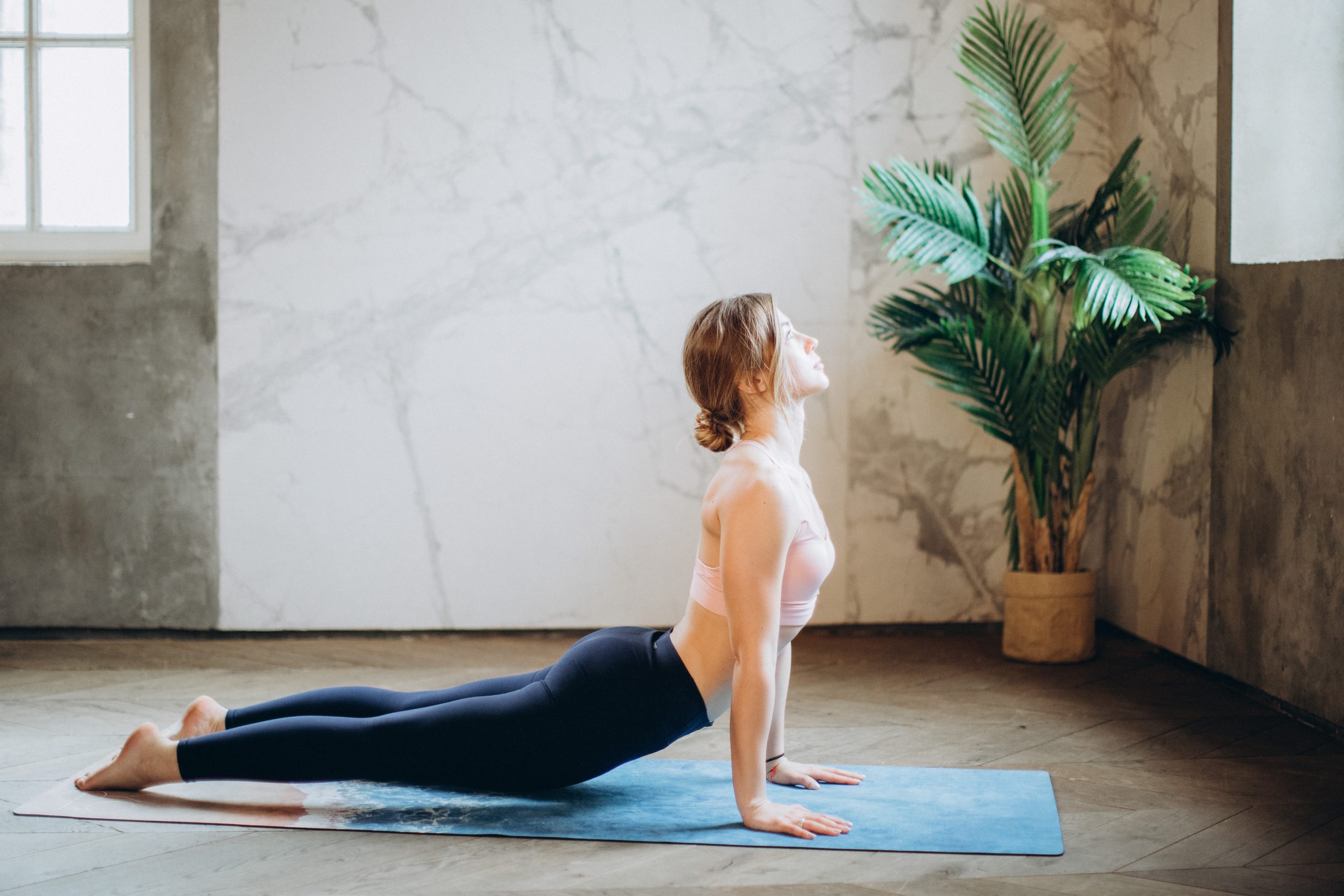 Woman stretching on yoga mat.